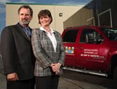 Couple Standing with Mobile Van